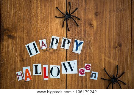 Happy Halloween Letters Cut Out From The Magazines And Black Spiders
