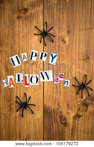 Happy Halloween Letters Cut Out From The Magazines And Black Spiders