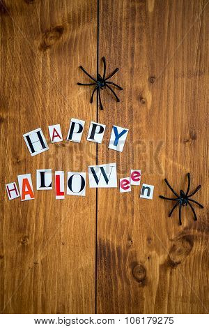 Happy Halloween Letters Cut Out From The Magazines And Black Spiders