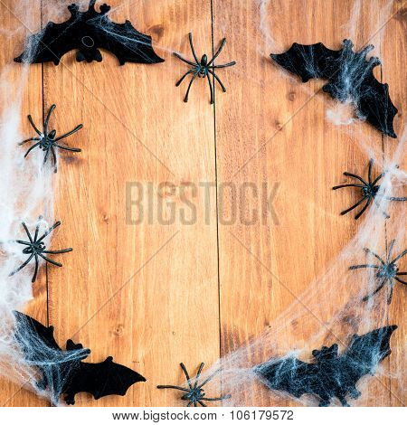 Halloween Symbols Bats, Web And Black Spiders On Wooden Background