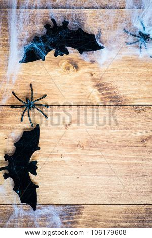 Halloween Symbols Bats, Web And Black Spiders On Wooden Background