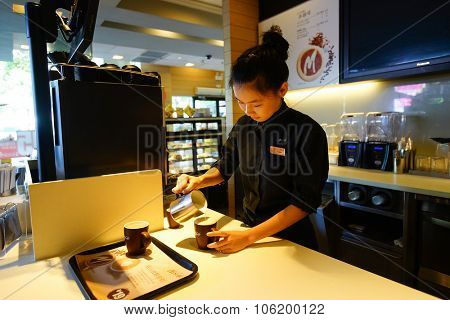 SHENZHEN, CHINA - OCTOBER 09, 2015: McCafe's barista preparing coffee. McCafe is a coffee house style food and drink chain, owned by McDonald's.