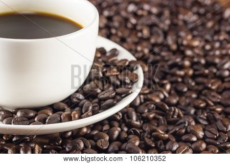 A Cup Of Coffee And Coffee Beans Background Warm Toning, Selective Focus