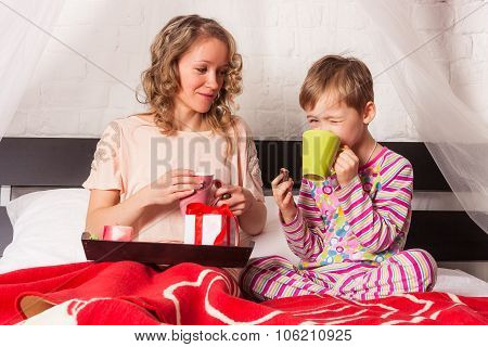 Son with his mother drinkig morning tea