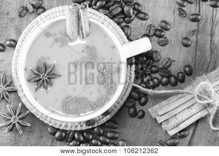 Coffee On The Cup With Coffee Beans And Cinnamon Sticks On Wood Background On Balck And White, Selec