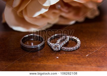 Two wedding rings, red roses