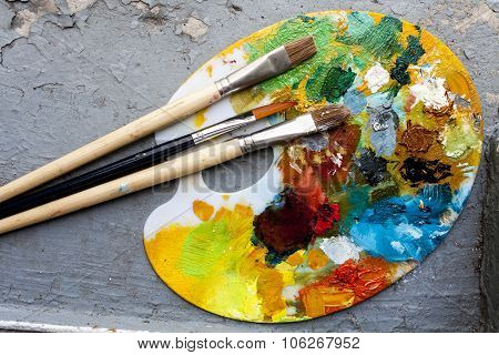 Brushes And Colorful Abstract Oil Colors Paiters Pallet, On Grunge Background