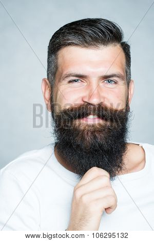 Grey-haired Man Pulling Beard
