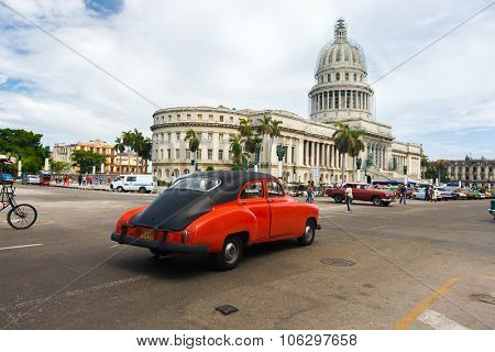 HAVANA, CUBA - JULY 16, 2013: Classic american car and Capitolio landmark in Old Havana,Cuba. Havana is tourist most popular destination and a capital of Cuba.