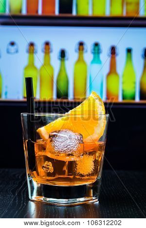 Glass Of Spritz Aperitif Aperol Cocktail With Orange Slices And Ice Cubes On Bar Table, Disco Lounge