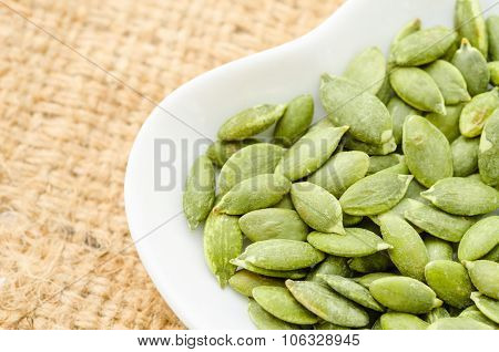 Raw Organic Pumpkin Pepita Seeds In A Bowl.