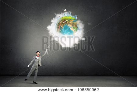 Businessman catch Earth planet with rope . Elements of this image are furnished by NASA