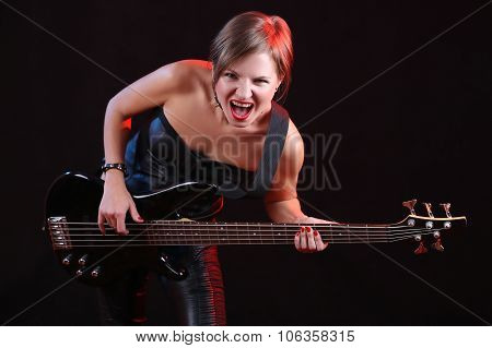 Fashion girl with guitar playing rock