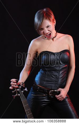 Fashion girl with guitar playing rock