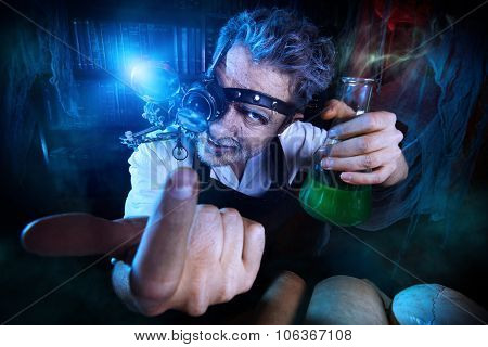 Portrait of a crazy medieval scientist working in his laboratory. Alchemist. Halloween.