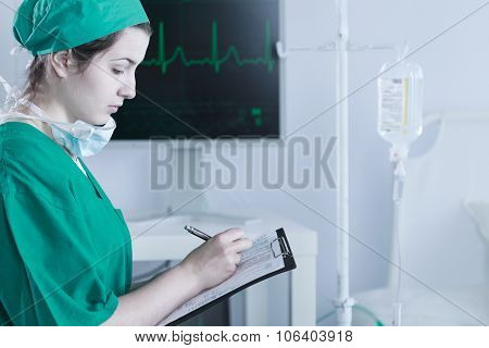 Female Doctor Completing Medical Documentation
