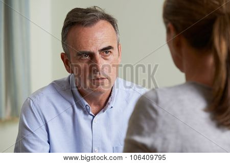 Depressed Mature Man Talking To Counsellor
