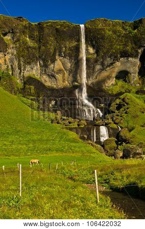 Waterfall from a cliff near Nupstadur farm