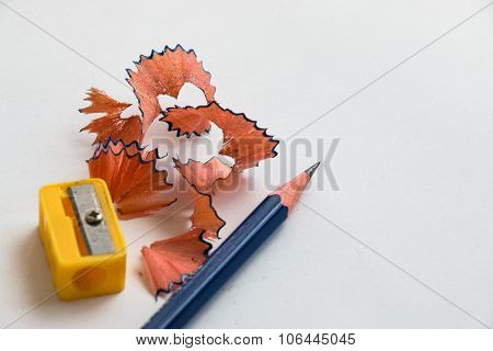 Pencil and pencil sharperner on white paper background