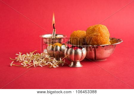 Beautifully Decorated Pooja Thali for diwali celebration to worship , having Indian sweet motichoor