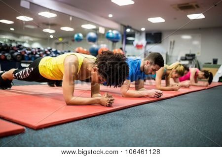Fit people working out in fitness class at the gym