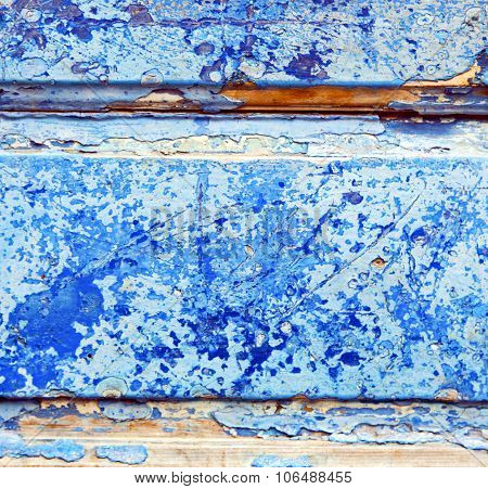 Stripped Paint In The Blue Wood Door And Rusty Nail
