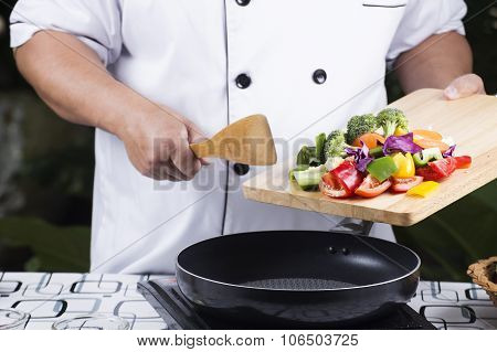 Chef Putting Vegetable To The Pan