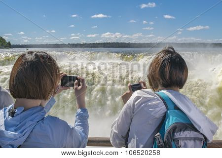 Tourists Taking Photos Of Devil Throat At Iguazu Park