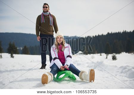 romantic winter  scene, happy young couple having fun on fresh show on winter vacatio, mountain nature landscape
