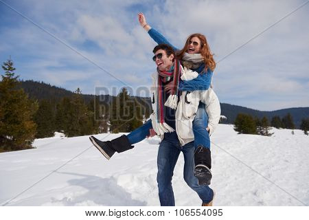 romantic winter  scene, happy young couple having fun on fresh show on winter vacatio, mountain nature landscape