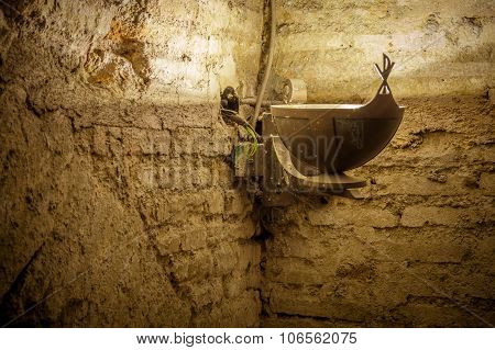 Old Cript Or Basement Textured Wall With Electrical Wires In The Corner And An Antique Metal Vintage