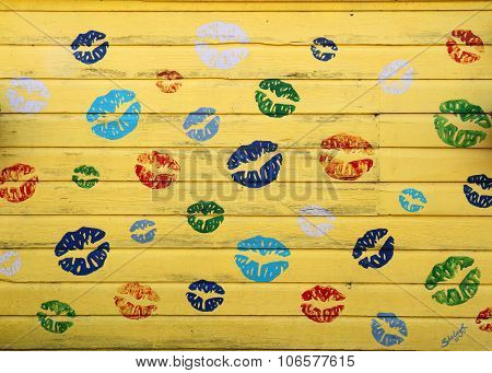 Abstract lips painted on yellow shed