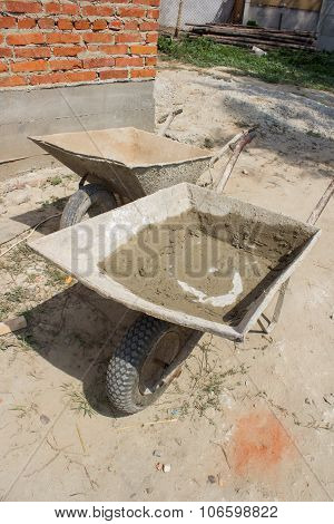 two construction wheelbarrows