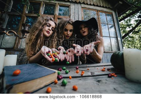 Three vintage witches perform magic ritual