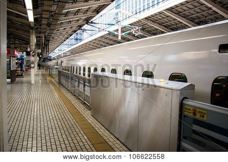 White commuter train park at platform in train station.
