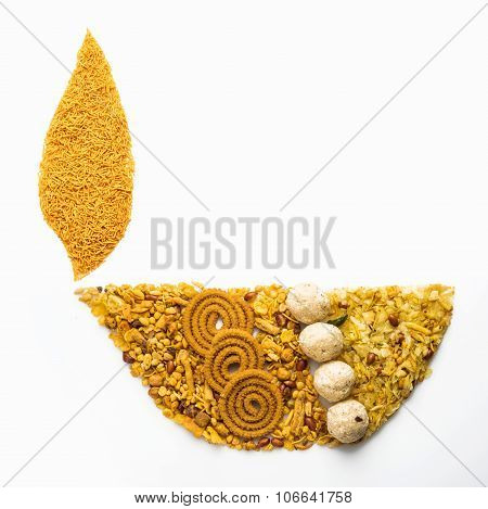 Traditional indian diwali snack or diwali food in diwali lamp form isolated on white. diwali greetin
