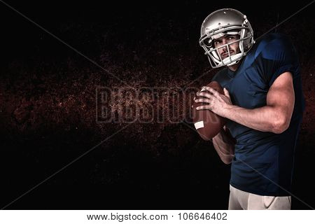 Sports manto throwing the ball against dark background