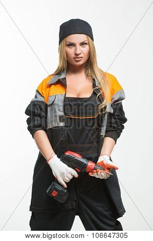 Young sexy female holding a cordless screwdriver