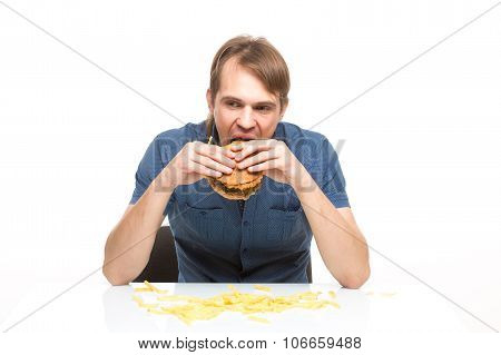 man is not careful eating tasteless burger.