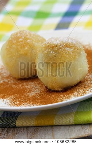 Sweet fruit dumplings sprinked with cinnamon and sugar, closeup
