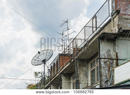 Satellite Dish And Attenna On A Old Building