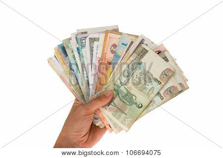 Fan of banknotes of various countries in the hand