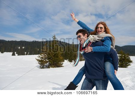 romantic winter  scene, happy young couple having fun on fresh show on winter vacatio, mountain nature landscape