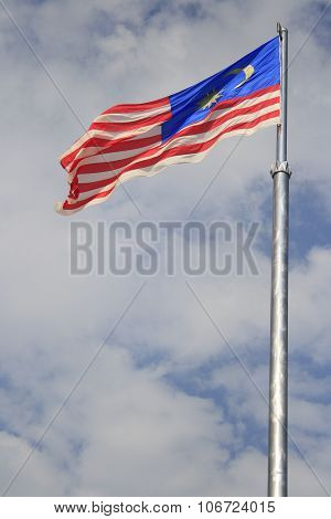 Malaysia flag waving against blue sky