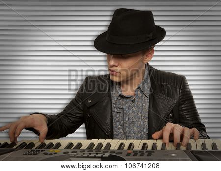 Man in the hat playing on a synthesizer