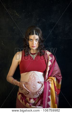 The pregnant woman with henna tattoo