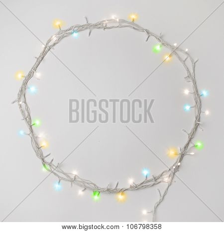 Series of tiny christmas lights. Round shape border made with decorative lights.