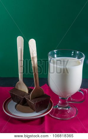 Two Belgian Chocolate Stirrers By Mug Of Milk.