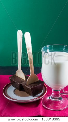 Two Belgian Chocolate Stirrers By Mug Of Milk.