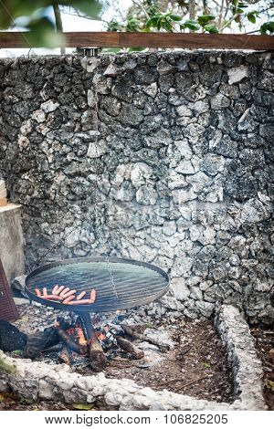 Image of a bbq grill outdoors near a wall